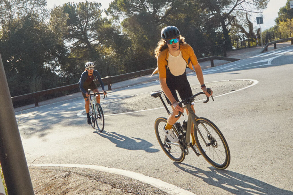 Two cyclists in an urban setting crossing a roundabout on Cannondale road bikes
